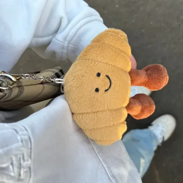 Cutesy Croissant Bag Charm on a bag